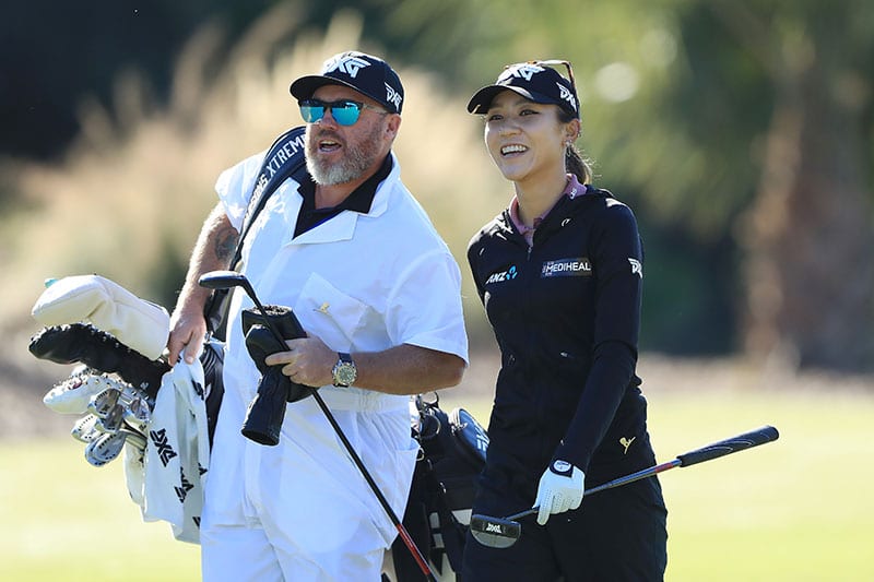 Lydia Ko reacts with her caddie after playing her second shot on the second hole during the first round of the CME Group Tour Championship in November 2019. (Photo by Sam Greenwood/Getty Images)